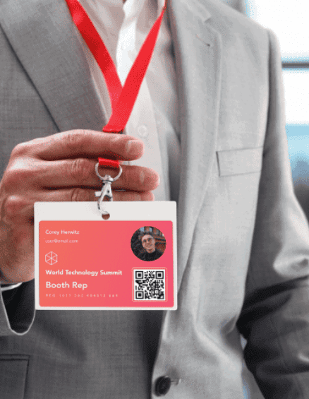 stock photo of a man holding a badge in his hand and wearing it around his neck